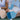 Two women sitting on pickleball court with GAMMA pickleball paddles